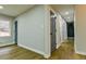 Hallway showcasing updated flooring, neutral paint colors, gray doors, and a window at 3421 Fawn Trl, Marietta, GA 30066
