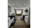 Renovated kitchen features updated white cabinets, stainless appliances and wood floor at 3421 Fawn Trl, Marietta, GA 30066