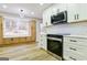 Spacious kitchen showcasing stainless steel appliances, white cabinets, and a large window for ample natural light at 3421 Fawn Trl, Marietta, GA 30066