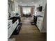 Well-lit kitchen with white cabinets, black appliances, and butcher block countertops at 3421 Fawn Trl, Marietta, GA 30066