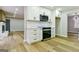 Well-lit kitchen with stainless steel appliances, white cabinets, and elegant countertops, perfect for cooking at 3421 Fawn Trl, Marietta, GA 30066