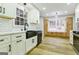 Bright kitchen features white and wood cabinets, complemented by modern stainless steel appliances and hardwood floors at 3421 Fawn Trl, Marietta, GA 30066