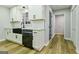 Updated kitchen with white cabinets, stainless steel appliances, and a farmhouse sink, ideal for cooking and entertaining at 3421 Fawn Trl, Marietta, GA 30066