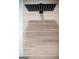 Close-up of modern showerhead with wood look tile wall at 3421 Fawn Trl, Marietta, GA 30066