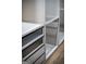 Close-up of custom walk-in closet featuring shelving, drawers, and wood floor at 3421 Fawn Trl, Marietta, GA 30066