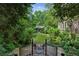 Lush backyard with manicured lawn, mature trees, and charming guest house at 240 Nacoochee Nw Dr, Atlanta, GA 30305