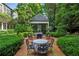 Charming brick patio with comfortable seating and beautiful views to the sunroom at 240 Nacoochee Nw Dr, Atlanta, GA 30305