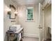Charming bathroom featuring a unique vanity, decorative mirror, and natural light at 240 Nacoochee Nw Dr, Atlanta, GA 30305