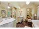 Bright bathroom with a marble countertop, clawfoot tub, vanity, and large mirror at 240 Nacoochee Nw Dr, Atlanta, GA 30305