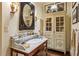 Vintage bathroom vanity with marble countertop and an antique-style cabinet and mirror at 240 Nacoochee Nw Dr, Atlanta, GA 30305
