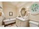 Bright bathroom featuring a clawfoot tub, unique round window and custom vanity with beautiful mirrors at 240 Nacoochee Nw Dr, Atlanta, GA 30305
