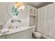 Elegant bathroom with white marble countertop, custom cabinetry, round window and tub/shower combo at 240 Nacoochee Nw Dr, Atlanta, GA 30305