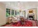 Inviting breakfast nook features a fireplace, large windows, and comfortable seating at 240 Nacoochee Nw Dr, Atlanta, GA 30305