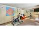 Home gym featuring an exercise bike, large mirror, and colorful artwork at 240 Nacoochee Nw Dr, Atlanta, GA 30305