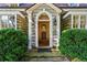 Elegant entryway with sidelights and view to the foyer, framed by lush greenery at 240 Nacoochee Nw Dr, Atlanta, GA 30305