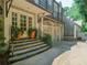 Charming home exterior with a stone staircase, mature landscaping, and a two-car garage at 240 Nacoochee Nw Dr, Atlanta, GA 30305