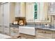 Bright kitchen with custom cabinetry, farmhouse sink, and modern stainless steel appliances at 240 Nacoochee Nw Dr, Atlanta, GA 30305