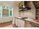 Rustic kitchenette with stone accent wall, custom cabinetry, and modern appliances at 240 Nacoochee Nw Dr, Atlanta, GA 30305