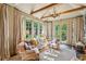 Sun-filled living room with large windows, comfortable seating, and elegant decor at 240 Nacoochee Nw Dr, Atlanta, GA 30305