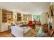 Bright living room featuring hardwood floors, built-in shelving, and ample seating at 240 Nacoochee Nw Dr, Atlanta, GA 30305