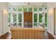 Bright living room with large windows, wood floors, and comfortable seating, offering stunning views of the surrounding greenery at 240 Nacoochee Nw Dr, Atlanta, GA 30305