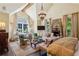 Elegant main bedroom features a stone fireplace, chandelier, sitting area, and large windows at 240 Nacoochee Nw Dr, Atlanta, GA 30305