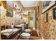 Stylish powder room with ornate wallpaper, vanity, and gilded light fixtures at 240 Nacoochee Nw Dr, Atlanta, GA 30305