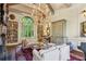 Elegant living room featuring exposed beams, a chandelier, and built-in bookshelves at 240 Nacoochee Nw Dr, Atlanta, GA 30305