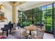 Bright sunroom with floor-to-ceiling windows and a view of the beautiful backyard at 240 Nacoochee Nw Dr, Atlanta, GA 30305