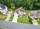 Aerial view of home featuring manicured lawn, mature landscaping, and traditional architectural design at 310 Medridge Dr, Alpharetta, GA 30022