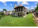 Backyard featuring a spacious lawn and a charming screened-in porch with stairs at 310 Medridge Dr, Alpharetta, GA 30022