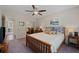 Comfortable bedroom featuring a wooden bed frame, soft lighting, and an adjacent doorway at 310 Medridge Dr, Alpharetta, GA 30022