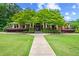 Community clubhouse featuring lush landscaping and welcoming entrance at 310 Medridge Dr, Alpharetta, GA 30022