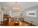 Dining area featuring hardwood floors, wainscoting, and an adjacent kitchen with breakfast bar at 310 Medridge Dr, Alpharetta, GA 30022