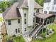 Rear exterior view of home showcasing well-maintained yard, screened porch, and wood staircase at 310 Medridge Dr, Alpharetta, GA 30022