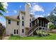 Back exterior of home with a screened in porch, wood stairs, and a large backyard at 310 Medridge Dr, Alpharetta, GA 30022