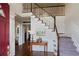 Bright foyer features hardwood floors, staircase with white railings, and elegant decor at 310 Medridge Dr, Alpharetta, GA 30022