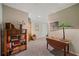 Basement hallway featuring a bookcase, table with lamp, decor, and neutral colors at 310 Medridge Dr, Alpharetta, GA 30022