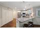 Well-lit kitchen with white cabinetry, granite countertops, a breakfast bar, and hardwood floors at 310 Medridge Dr, Alpharetta, GA 30022