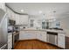 Bright kitchen with white cabinets, granite countertops, stainless steel appliances, and hardwood floors at 310 Medridge Dr, Alpharetta, GA 30022