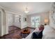 Inviting living room with hardwood floors, wainscoting, and natural light from large windows at 310 Medridge Dr, Alpharetta, GA 30022