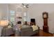 Bright, open living room with high ceilings, a fireplace, large windows, and hardwood floors, perfect for entertaining at 310 Medridge Dr, Alpharetta, GA 30022