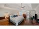 Inviting main bedroom with tray ceiling, hardwood floors, and a comfortable bed at 310 Medridge Dr, Alpharetta, GA 30022