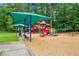 Community playground with slides, swings, and play equipment, shaded by mature trees and covered seating at 310 Medridge Dr, Alpharetta, GA 30022