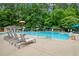 Community pool surrounded by lounge chairs with lifeguard stand and shade at 310 Medridge Dr, Alpharetta, GA 30022