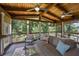 Relax on the screened porch with a comfortable seating area that overlooks the serene, wooded backyard at 310 Medridge Dr, Alpharetta, GA 30022