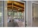 Inviting screened-in porch with wood ceiling, ceiling fan, and comfortable seating area with a view of the wooded backyard at 310 Medridge Dr, Alpharetta, GA 30022