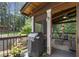 View of the cozy screened porch with wood ceiling and a dining area with a view of the wooded backyard at 310 Medridge Dr, Alpharetta, GA 30022
