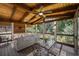 A lovely screened porch offers both a comfortable sitting area and a dining space overlooking a lush, green backyard at 310 Medridge Dr, Alpharetta, GA 30022