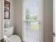 Neat powder room with a toilet and window, offering natural light and a view of the outdoors at 310 Medridge Dr, Alpharetta, GA 30022